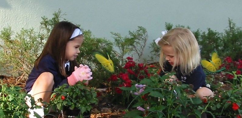 Children exploring a garden, from Ivy Prep’s website